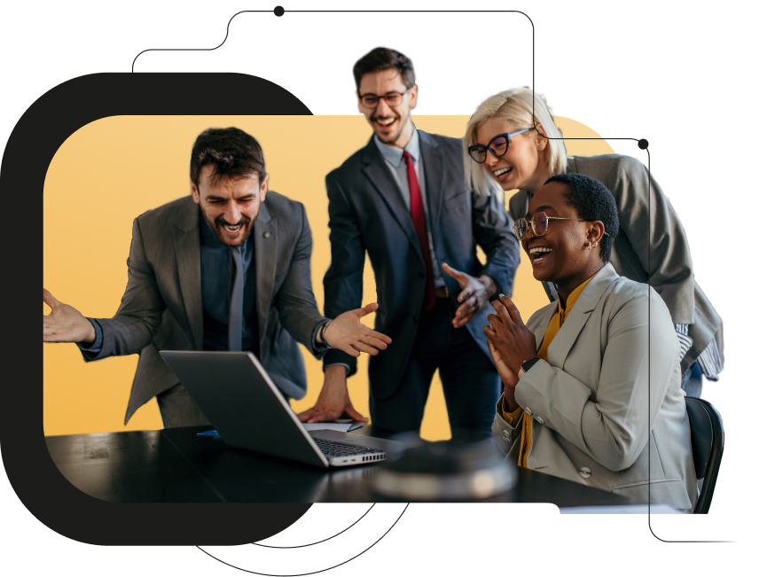excited coworkers in business attire huddled around computer