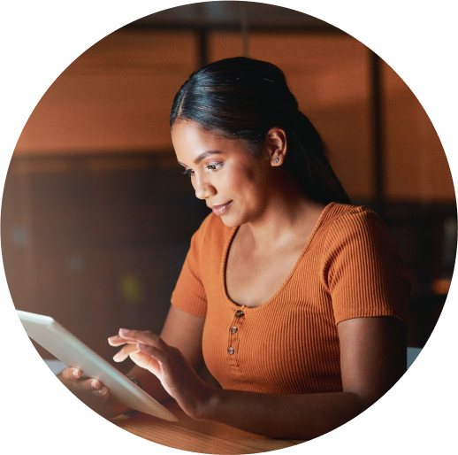 woman on tablet smiling while looking using device